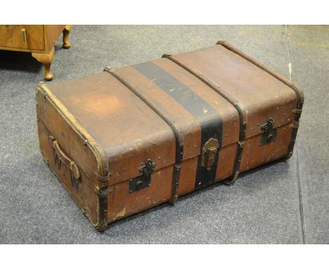 A wood bound travel trunk.