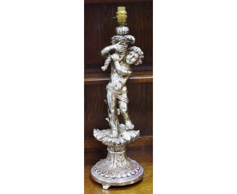 A large chromed metal table lamp base in the form of a cherub