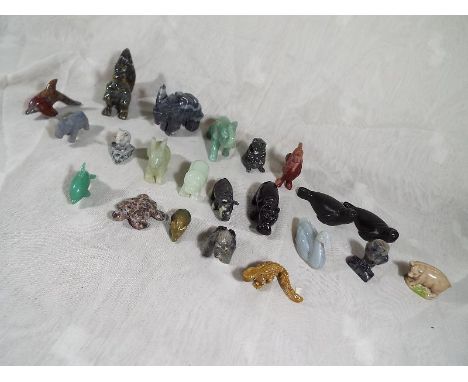 A collection in excess of twenty hand carved miniature animals made from various materials to include jade, hardstone, soapst