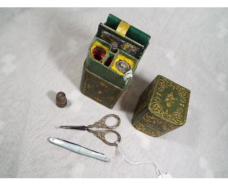 A lady's white metal companion set, comprising mirror, thimble, penknife, tape measure, scissors, button hook and similar enc