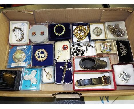 A collection of display boxes containing good quality costume jewellery predominately brooches to include some silver .Includ