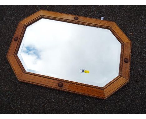 A good quality oak framed octagonal bevel edge wall mirror - included in the lot is a small collection of early 20th century 