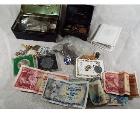 Two cash tins containing a quantity of predominantly UK pre decimal coins, some world bank notes, enamel pin badges and simil