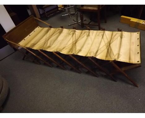 A military 'Shut Up'  Cabinetta Cabinet bed / cot with  hardwood accordion frame which folds up and converts to a seat or tab