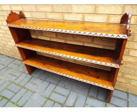 A good quality 3 shelf bookcase with carved design 96cm x 128cm x 26cm