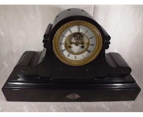 A French black marble mantel clock, the case of drum head form with incised flutes, gilded decoration and inlaid malachite, w