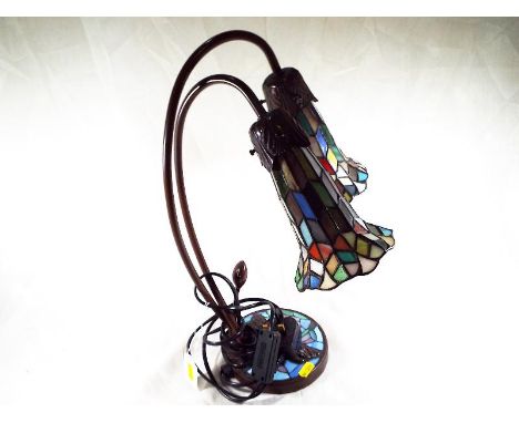 A Tiffany style lamp, the base decorated with a dragonfly