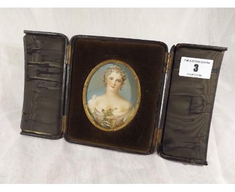 An 19th century miniature portrait depicting a young lady, signed by the artist, set in a folding leather case, under glass -