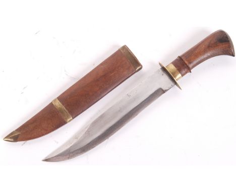 A 20th century Northern Indian wooden handled Bowie / hunting knife. Within brass banded wooden scabbard. Measures 25cm long.