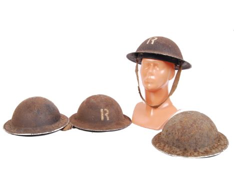 A collection of 4x original WWII Second World War Civil Defence steel helmets. Two marked ' R ' for heavy rescue. All with or