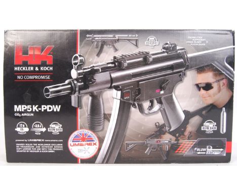 A Heckler &amp; Koch made ' MP5K - PDW ' C02 powered BB airsoft airgun. With folding stock, picatinny rail, empty magazine, b