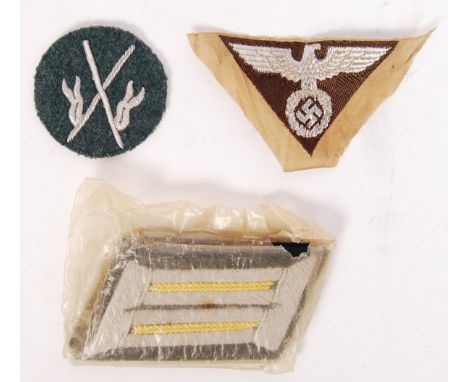A collection of original WWII Second World War Nazi German Third Reich uniform items to include Cavalry shoulder patches ( in