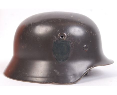 A believed original late issue WWII Second World War Nazi German Third Reich M42 Infantry Helmet, with covered up single deca