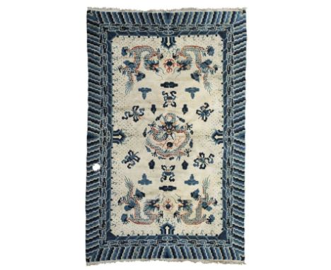 TWO CHINESE CARPETS  LATE 19TH/EARLY 20TH CENTURY  one with cream field with five dragons, within blue cloud scroll border; t
