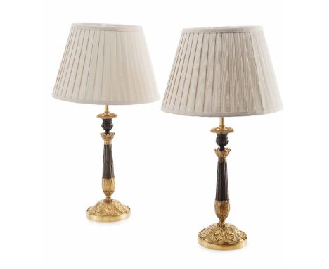 PAIR OF RESTAURATION PATINATED AND GILT BRONZE LAMPS  19TH CENTURY  converted from candlesticks, each with a gadrooned drip t