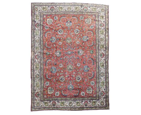 TABRIZ CARPET  NORTHWEST PERSIA, EARLY/MID 20TH CENTURY  the red field with allover palmette and foliate vine pattern, within