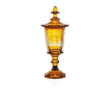 LARGE BOHEMIAN AMBER GLASS COVERED VASE  LATE 19TH CENTURY  the cover with a spike finial and lobed edge; the facetted cup en