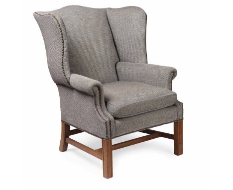 GEORGE III STYLE MAHOGANY FRAMED WING ARMCHAIR  MODERN  with a loose cushion seat, upholstered in light blue tweed with nail 