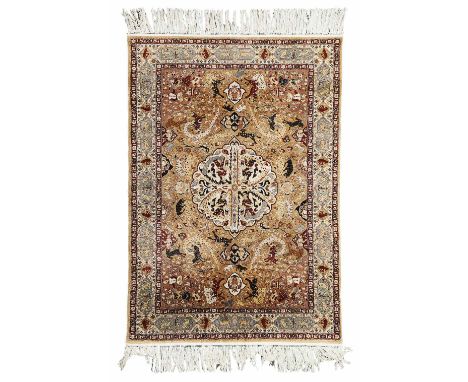 CENTRAL PERSIAN SILK 'HUNTING' RUG  LATE 20TH CENTURY  the light brown field with cream angel filled medallion, brown spandre