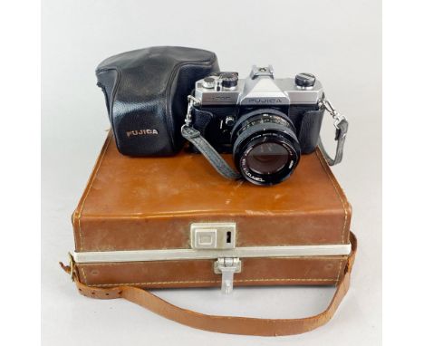 A cased vintage Polaroid camera together with a Fujica single lens reflex camera.