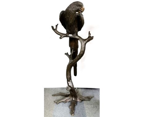 A heavy quality bronze sculpture of a parrot perched on a branch, H. 158cm.