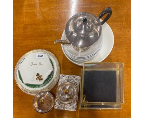 A group of china and glass items with a silver plated teapot.