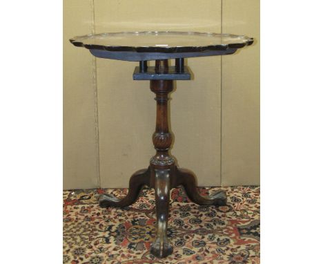 An Edwardian pie-crust occasional table with birdcage vase shaped pillar and tripod with claw and ball supports finished in a