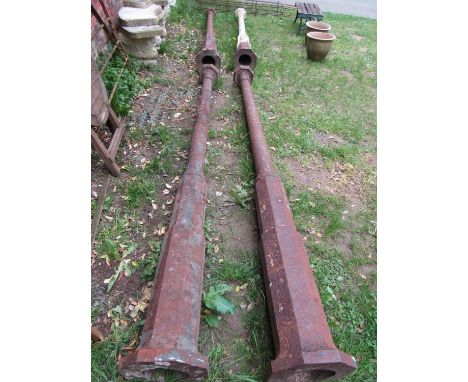 A set of four weathered heavy gauge cast iron architectural columns with octagonal caps and bases, 290 cm 