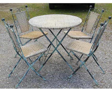 A light green painted and weathered folding heavy gauge iron work and split cane terrace suite, comprising circular top table