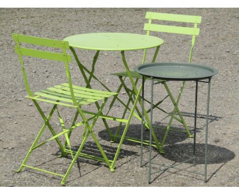 A light steel three piece folding bistro set with lime green painted finish, together with a further painted garden table wit