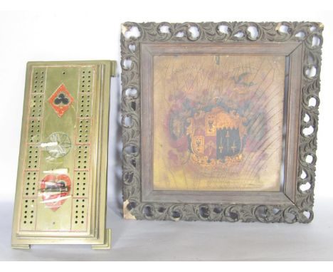 A Victorian brass cribbage board stamped Bedminster Bristol, 30cm, and a painted, Armorial  wood panel. 