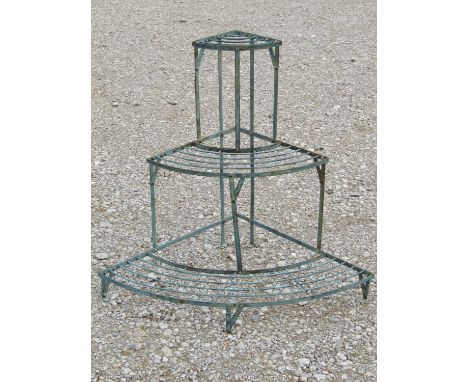 A green painted and weathered light steel floorstanding conservatory/garden corner plant stand on three graduated bow fronted