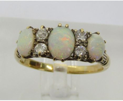 Antique 18ct opal and diamond ring, set with three cabochon opals interspaced with four old-cut diamonds, size R, 3.9g, conta