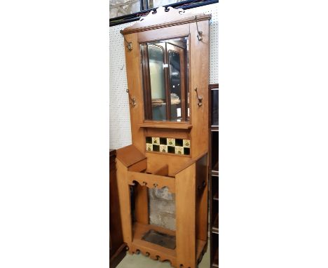 An art nouveau oak hall stand with mirror back, brass hooks and ceramic tiles, and two divisional stick stand, 75cm wide 