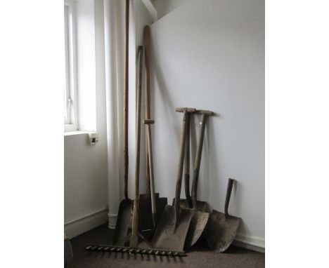 A small collection of vintage long wooden handled gardening related hand tools to include a selection of various spades, a wo