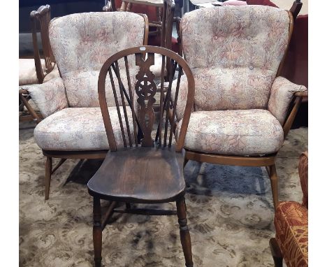 A pair of Ercol stick back armchairs with upholstered finish together with a single Windsor kitchen chair 