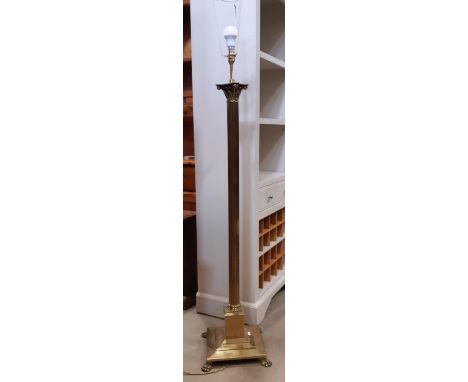 A brass lamp standard in the form of an ionic column on a square cut base 