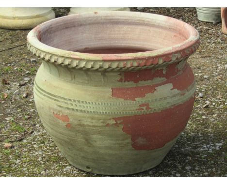 A large weathered light green painted terracotta circular planter with banded detail, 64 cm diameter x 50 cm high 