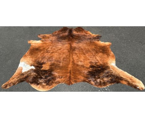 A cow hide rug/covering, branded R, with one small hole, 220cm x 180cm approx. 