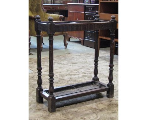 A late Victorian two divisional stick stand with carved supports 