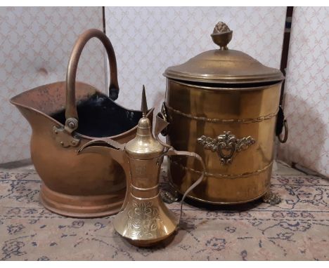 A Turkish brass coffee pot of traditional form, a copper coal helmet and a further brass coal scuttle 