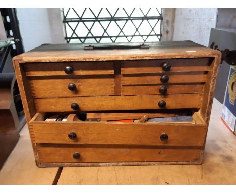 An oak engineers cabinet fitted with eight various drawers containing a full and unsorted collection of associated tools 