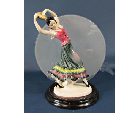 An art deco style table lamp with figure of a gypsy lady holding a pose, with glass panel shade, set on a wooden base 