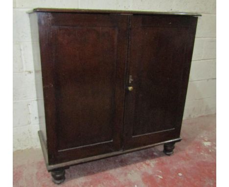 A useful oak side cupboard enclosed by two panelled doors with central shelf, 110cm wide, together with a simple foldover top