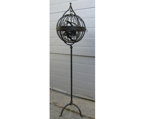 An encased spherical hinged basket Gimble lamp? hung in a floorstanding steel frame, 124 cm high 