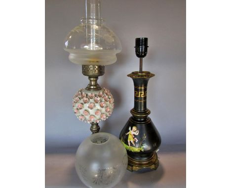 A black Greek design vase table lamp , an oil lamp with applied flower heads to the font, and a spare glass shade. 