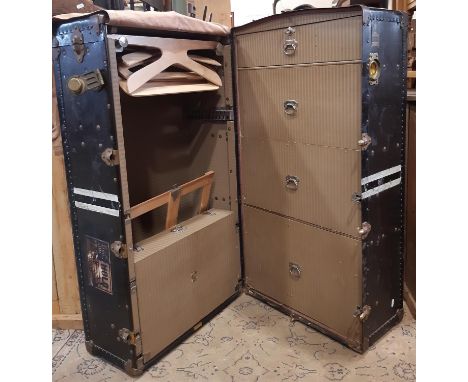 A vintage Oshkosh travelling trunk (Wisconsin USA) with steel banded riveted borders, with patent date 1924 