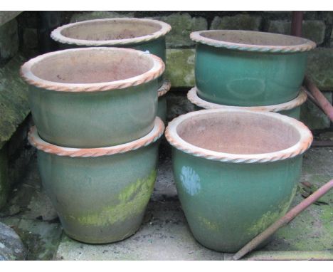 Seven weathered light green glazed contemporary planters of circular tapered form with incised flared rims, 38cm diameter x 3