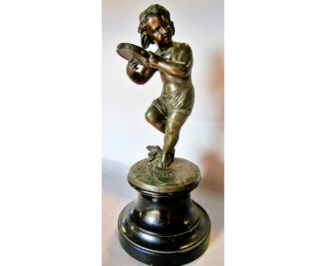 A spelter statue of a young girl doing a jig and playing a tambourine, raised on a socle base, 32cm tall. 
