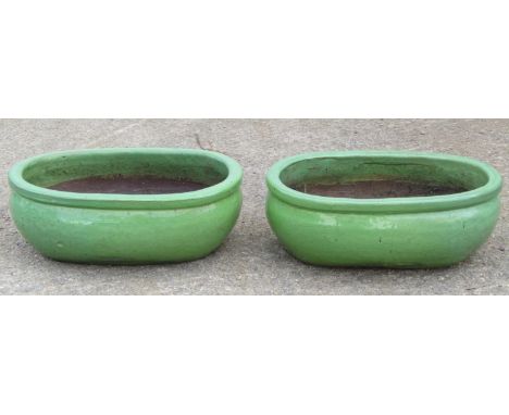 A pair of oval light green glazed planters, 47cm long x 30cm wide x 17cm high